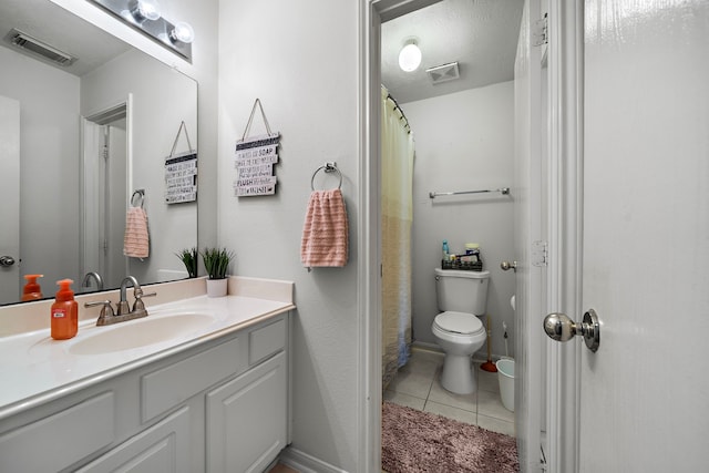 bathroom with visible vents, tile patterned flooring, vanity, and toilet
