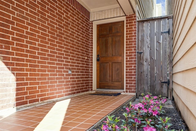 property entrance featuring brick siding