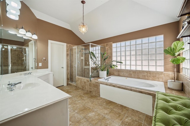 bathroom featuring a bath, a stall shower, vanity, and lofted ceiling