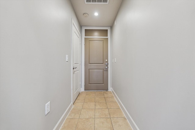 doorway to outside featuring visible vents, baseboards, recessed lighting, and light tile patterned floors