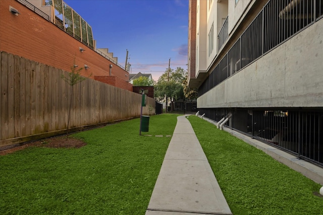 view of home's community featuring fence and a yard