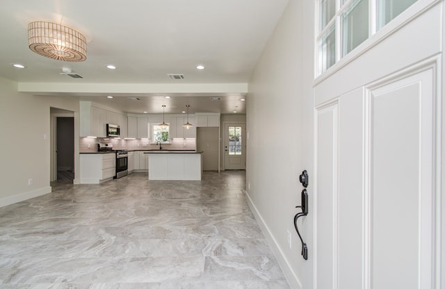 624 Willow Ln, Eagle Lake, TX 77434 - kitchen with appliances with stainless steel finishes, baseboards, dark countertops, light marble finish floors, and backsplash