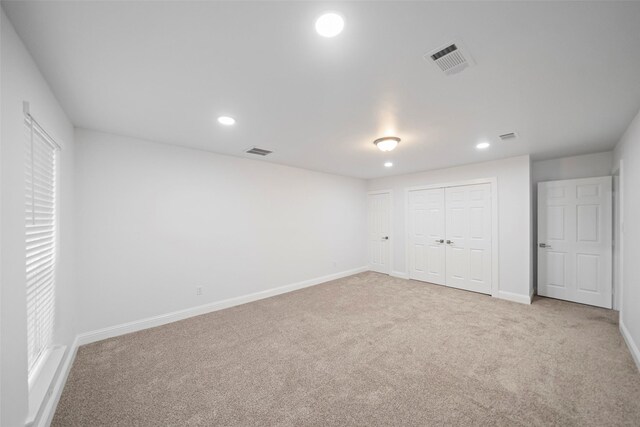 unfurnished bedroom featuring recessed lighting, carpet flooring, and visible vents