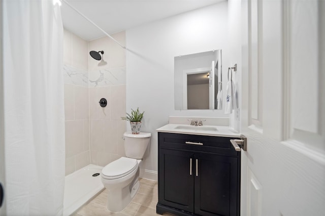 full bath with tile patterned flooring, vanity, a tile shower, and toilet