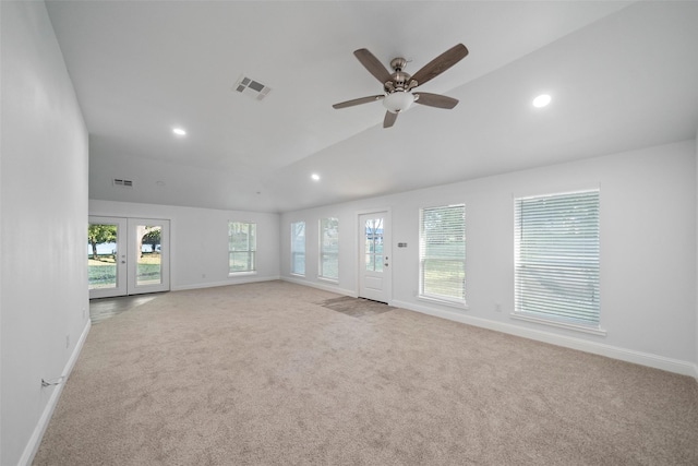 unfurnished living room with visible vents, baseboards, carpet, french doors, and lofted ceiling