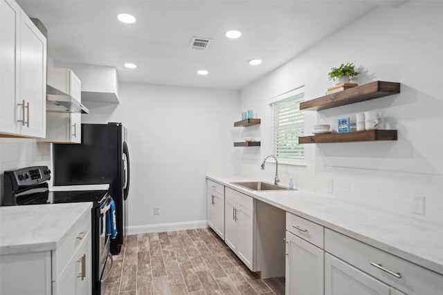 kitchen featuring stainless steel electric range oven, visible vents, range hood, open shelves, and a sink
