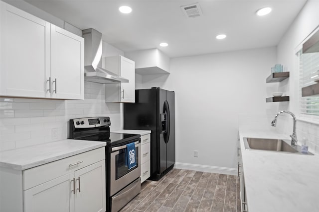 161 S Lakeway Cir, Trinity, TX 75862 - kitchen featuring stainless steel range with electric stovetop, wall chimney exhaust hood, open shelves, backsplash, and white cabinetry