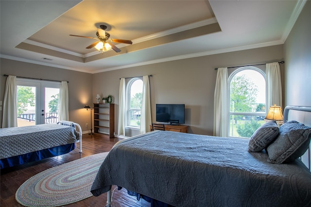 bedroom featuring access to outside, french doors, visible vents, a raised ceiling, and wood finished floors