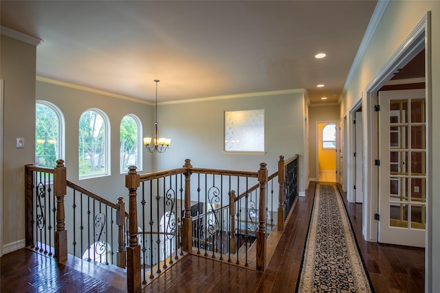 hall featuring an upstairs landing, a notable chandelier, wood finished floors, and a healthy amount of sunlight