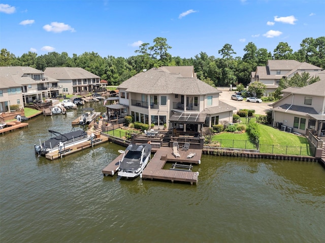 331 Old Aqua Lndg, Montgomery, TX 77356 - dock area featuring a fenced backyard, a water view, a lawn, a balcony, and a residential view