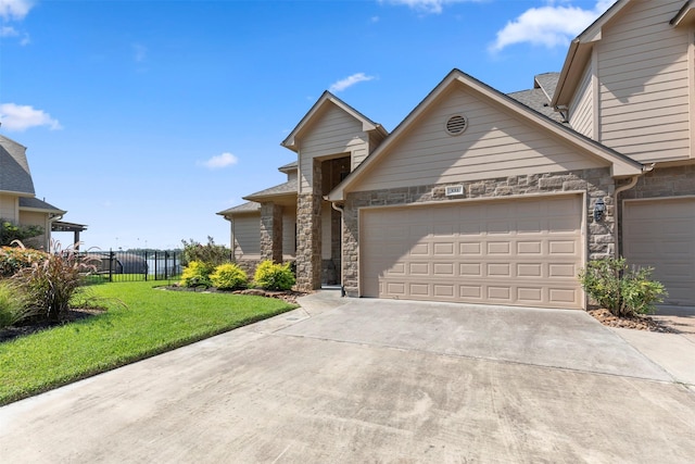 331 Old Aqua Lndg, Montgomery, TX 77356 - traditional-style house featuring concrete driveway, a garage, stone siding, and a front lawn