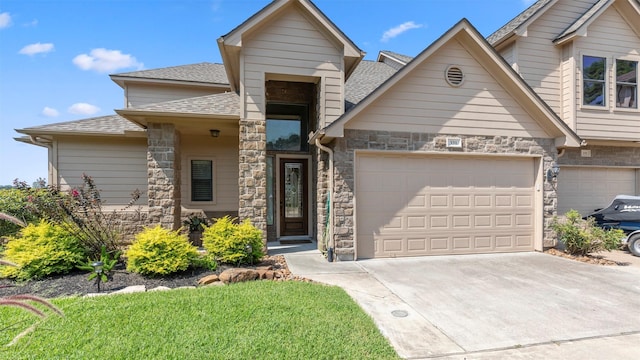 331 Old Aqua Lndg, Montgomery, TX 77356 - view of front of home featuring an attached garage, driveway, stone siding, and a shingled roof