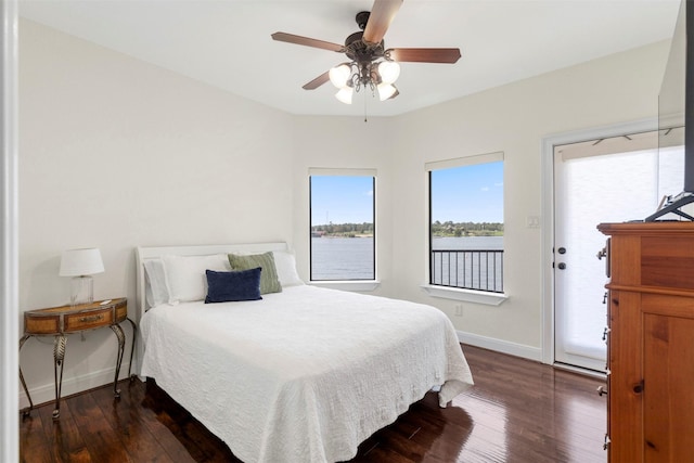 331 Old Aqua Lndg, Montgomery, TX 77356 - bedroom with ceiling fan, dark wood finished floors, a water view, access to exterior, and baseboards