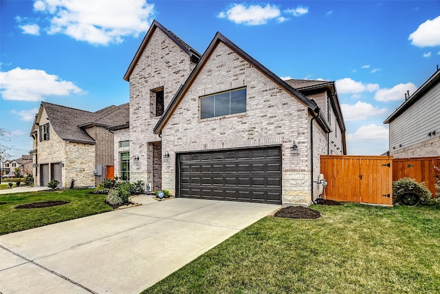 21123 Coral View Dr, Cypress, TX 77433 - french country inspired facade featuring an attached garage, concrete driveway, a front lawn, and a gate