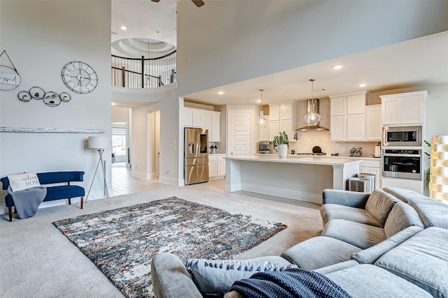 21123 Coral View Dr, Cypress, TX 77433 - living room featuring baseboards, light carpet, recessed lighting, a high ceiling, and ceiling fan