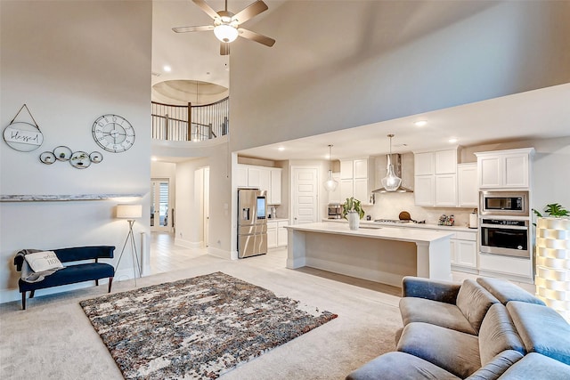 21123 Coral View Dr, Cypress, TX 77433 - living room featuring a high ceiling, ceiling fan, baseboards, and recessed lighting