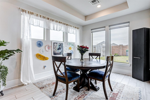 21123 Coral View Dr, Cypress, TX 77433 - dining area featuring a raised ceiling, visible vents, baseboards, and wood finish floors