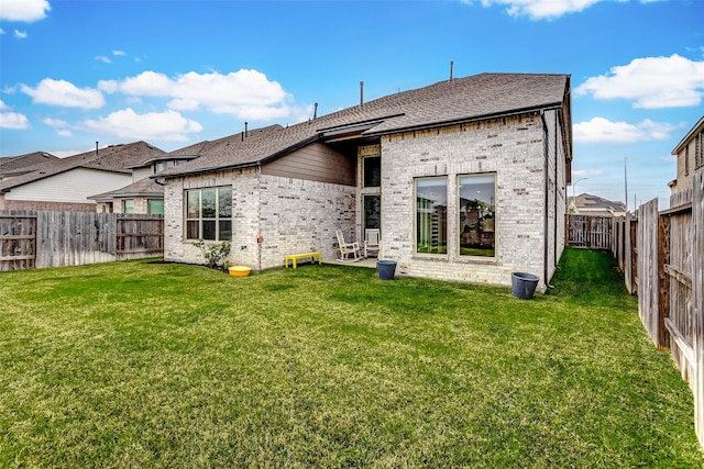 21123 Coral View Dr, Cypress, TX 77433 - rear view of house with a yard, brick siding, a fenced backyard, and a shingled roof