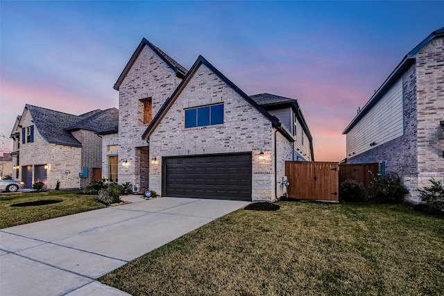 21123 Coral View Dr, Cypress, TX 77433 - french country home featuring a yard, a garage, driveway, and a gate