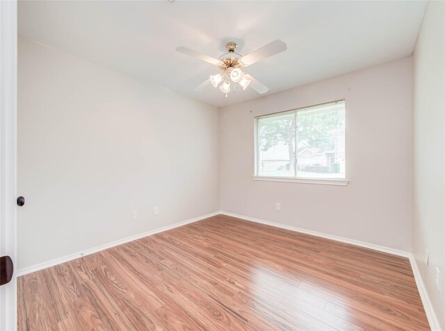 1311 Holly Lake Ct, Katy, TX 77450 - spare room with light wood finished floors, baseboards, and ceiling fan