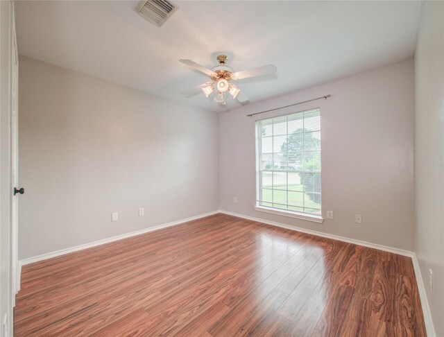 1311 Holly Lake Ct, Katy, TX 77450 - empty room with baseboards, a ceiling fan, wood finished floors, and visible vents