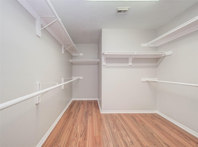 1311 Holly Lake Ct, Katy, TX 77450 - spacious closet with light wood-type flooring and visible vents