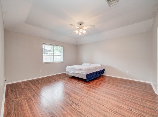 1311 Holly Lake Ct, Katy, TX 77450 - bedroom with baseboards, a ceiling fan, visible vents, and light wood-style flooring