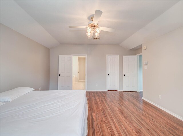 1311 Holly Lake Ct, Katy, TX 77450 - bedroom featuring lofted ceiling, wood finished floors, visible vents, and baseboards