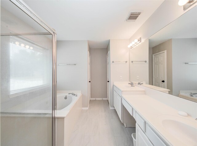 1311 Holly Lake Ct, Katy, TX 77450 - bathroom with a garden tub, a sink, marble finish floor, double vanity, and visible vents
