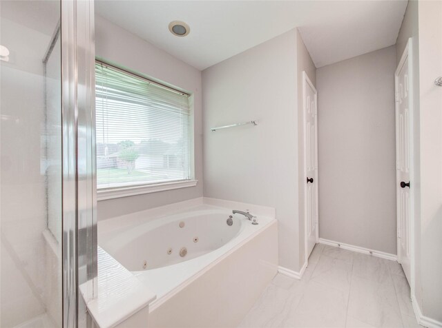 1311 Holly Lake Ct, Katy, TX 77450 - bathroom featuring a whirlpool tub, a shower stall, marble finish floor, and baseboards