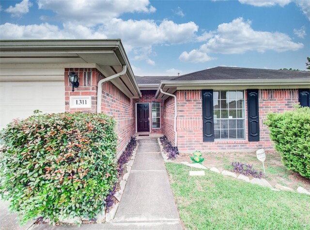 1311 Holly Lake Ct, Katy, TX 77450 - view of exterior entry featuring brick siding and a garage
