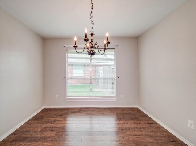 1311 Holly Lake Ct, Katy, TX 77450 - spare room with an inviting chandelier, dark wood-style floors, and baseboards