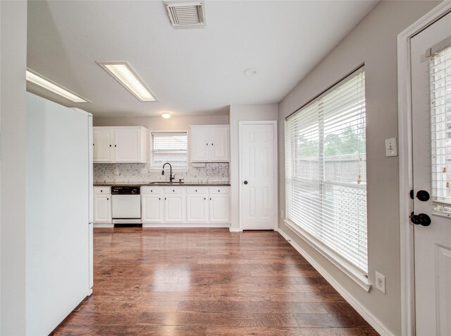 1311 Holly Lake Ct, Katy, TX 77450 - kitchen with a sink, tasteful backsplash, visible vents, white dishwasher, and wood finished floors