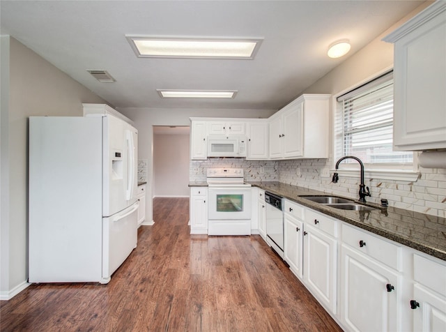 1311 Holly Lake Ct, Katy, TX 77450 - kitchen featuring a sink, dark wood-style flooring, visible vents, backsplash, and white appliances