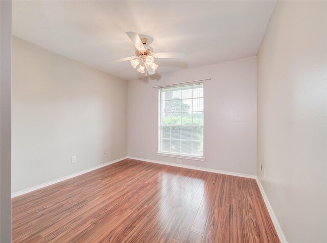 1311 Holly Lake Ct, Katy, TX 77450 - unfurnished room featuring baseboards, wood finished floors, and ceiling fan