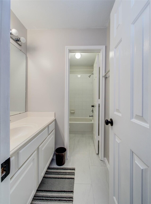 1311 Holly Lake Ct, Katy, TX 77450 - full bath with washtub / shower combination, baseboards, marble finish floor, and vanity