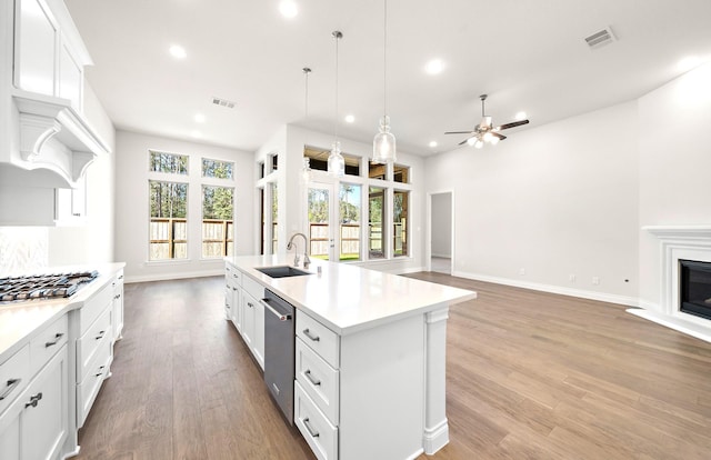 8215 Mount Washburn Ln, Porter, TX 77365 - kitchen featuring a sink, open floor plan, ceiling fan, recessed lighting, and stainless steel appliances