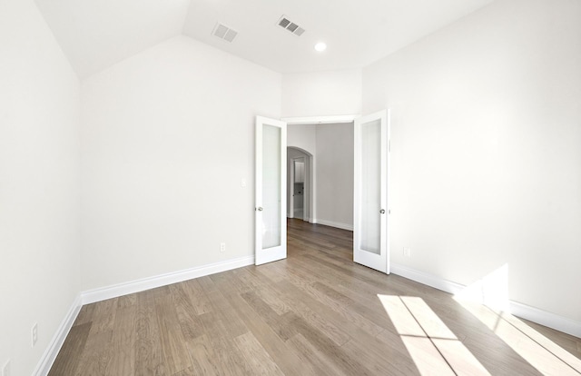 8215 Mount Washburn Ln, Porter, TX 77365 - spare room with arched walkways, light wood finished floors, visible vents, and baseboards