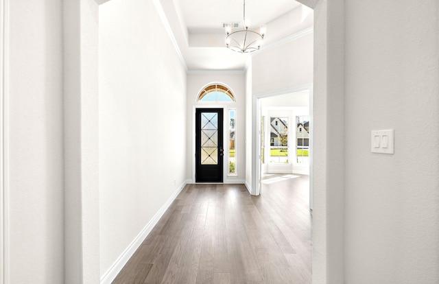 8215 Mount Washburn Ln, Porter, TX 77365 - entrance foyer featuring a notable chandelier, baseboards, crown molding, visible vents, and wood finished floors