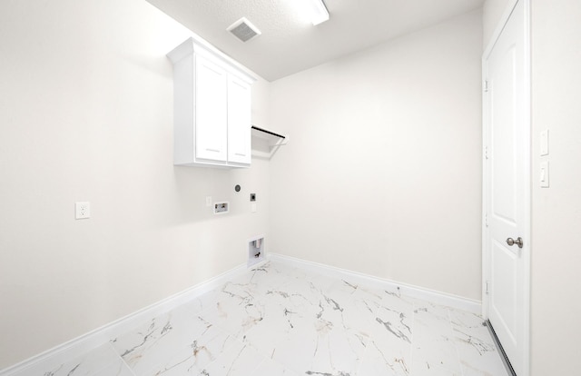 8215 Mount Washburn Ln, Porter, TX 77365 - laundry area featuring marble finish floor, baseboards, cabinet space, and electric dryer hookup