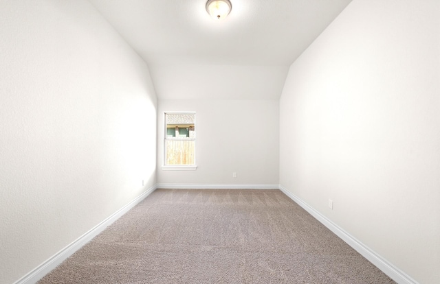 8215 Mount Washburn Ln, Porter, TX 77365 - spare room with light carpet, baseboards, and lofted ceiling