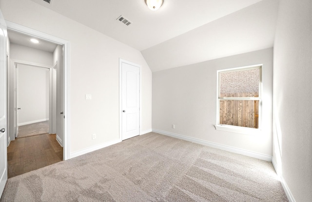 8215 Mount Washburn Ln, Porter, TX 77365 - unfurnished bedroom featuring visible vents, baseboards, vaulted ceiling, and carpet floors
