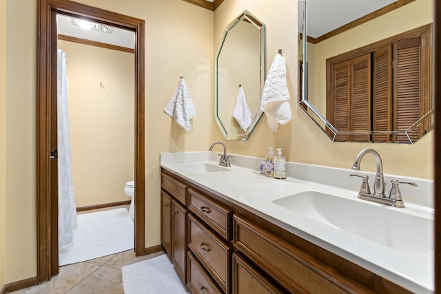 bathroom with toilet, a sink, and ornamental molding