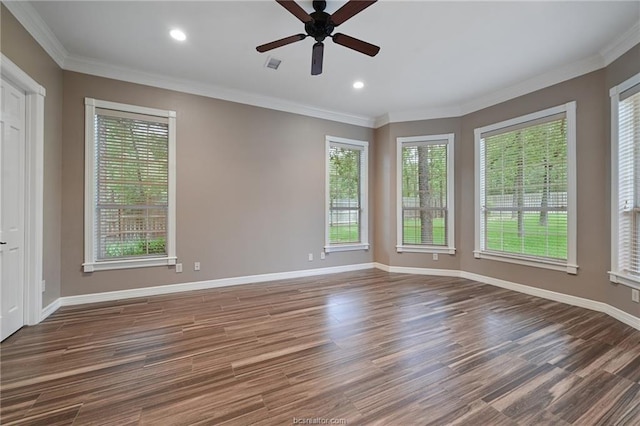spare room with a wealth of natural light, visible vents, baseboards, and a ceiling fan