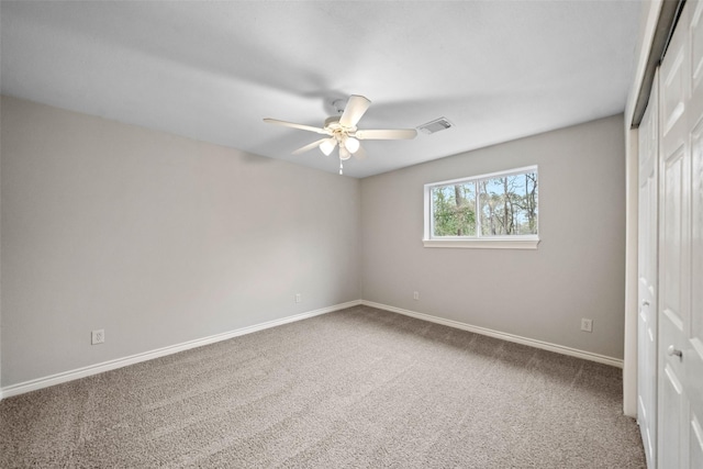 unfurnished bedroom featuring visible vents, baseboards, a closet, a ceiling fan, and carpet flooring