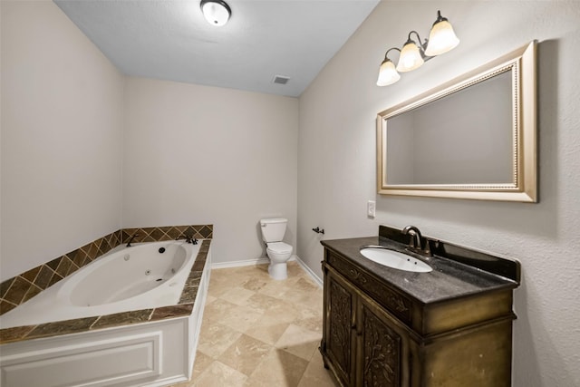 bathroom with toilet, a jetted tub, vanity, and visible vents