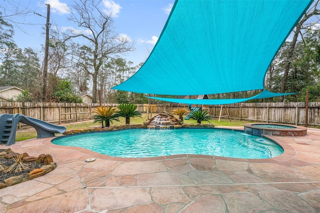 view of pool with a patio, a pool with connected hot tub, a fenced backyard, and a water slide
