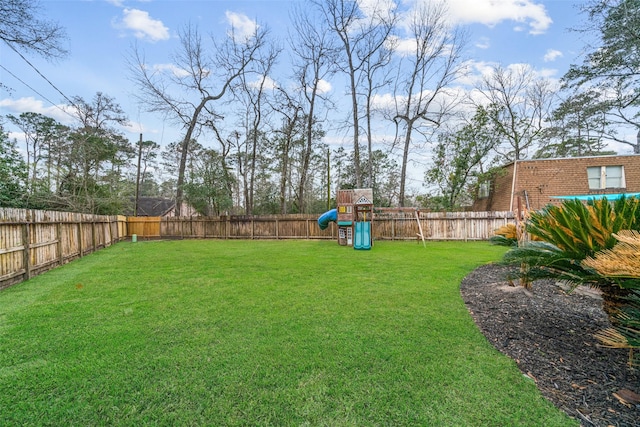 view of yard featuring a fenced backyard and a playground
