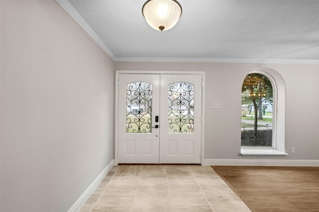 entrance foyer with crown molding and baseboards