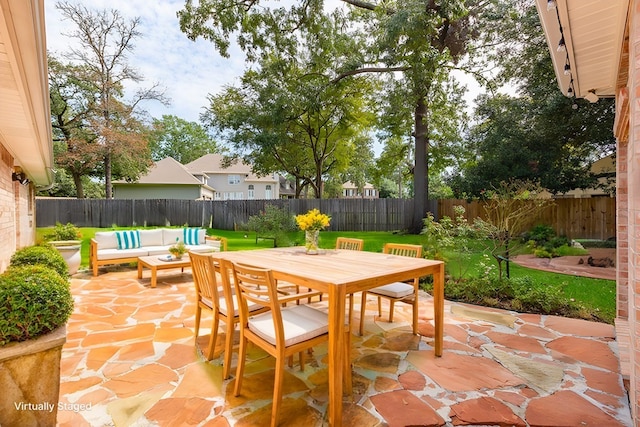 view of patio / terrace with outdoor dining space, an outdoor hangout area, and a fenced backyard